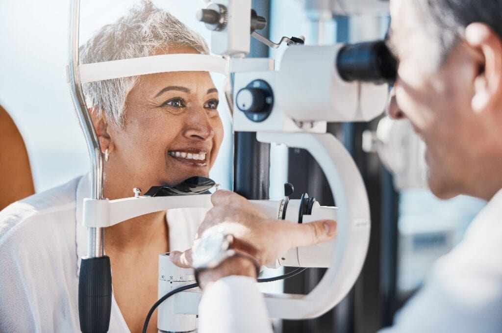 Senior woman, eye exam and optometrist with medical eyes test at doctor consultation. Vision, healthcare focus and old female patient with consulting wellness expert for lens and glasses check